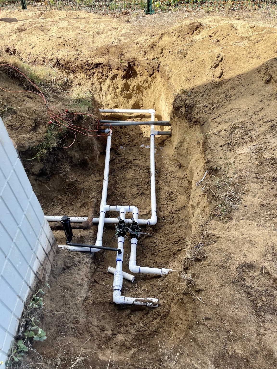 Deep trench with full PVC manifold and valves for a large irrigation system