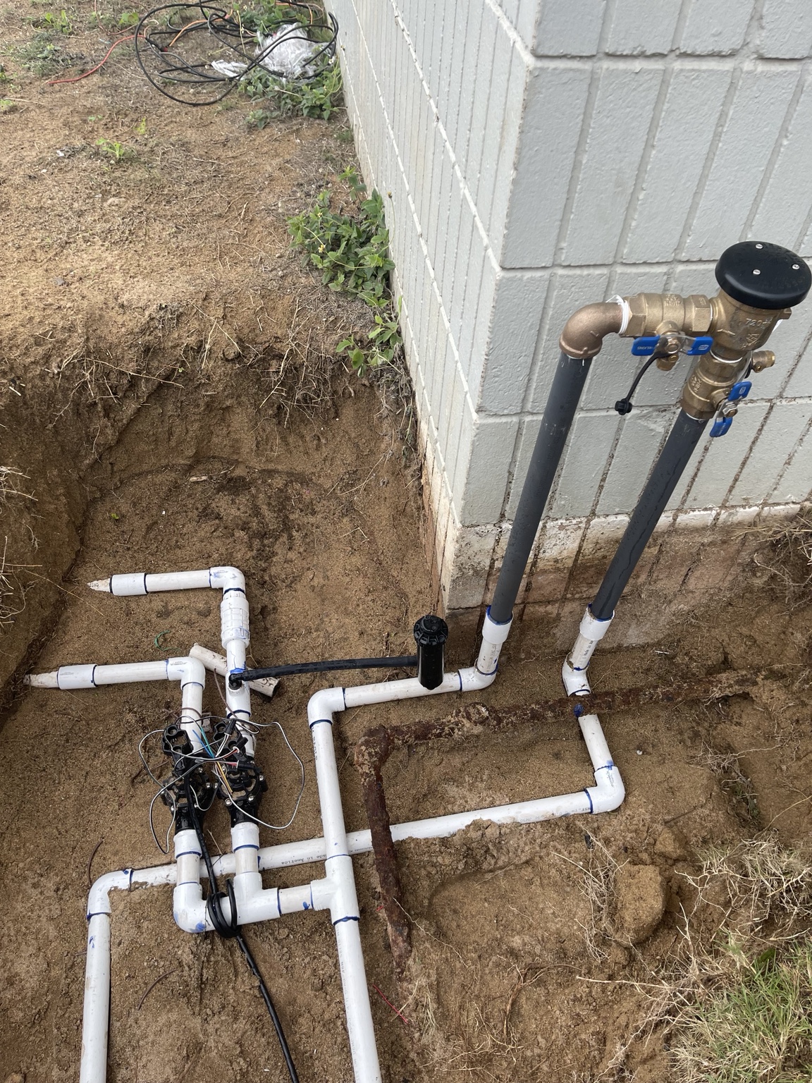 Fresh mainline manifold with backflow preventer riser at a Pasco jobsite