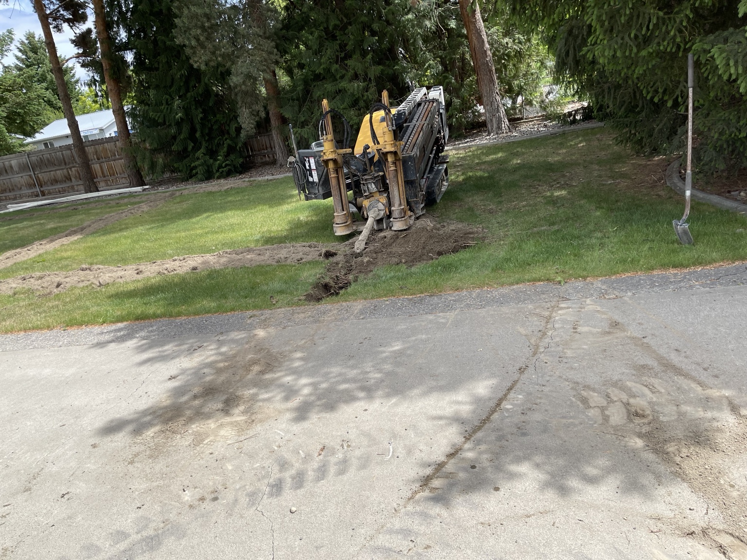 Vermeer directional boring machine running a line under a driveway